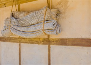 Traditional Korean sleeping mats hanging in rope on exterior wall in South Korea