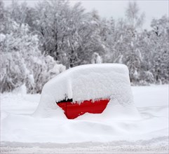 A red Smart, a tiny car, parked and completely covered in snow, winter, Munich, Bavaria, Germany,