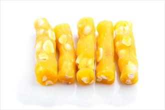 Yellow traditional turkish delight (rahat lokum) with peanuts isolated on white background. side
