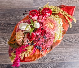 Bouquet of autumn flowers on a frame on a wooden background. floristic composition