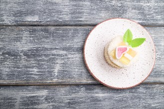 Decorated cake with milk and coconut cream on a gray wooden background. top view, flat lay, copy
