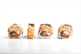Four Japanese maki sushi rolls in a row with salmon, sesame and cream cheese isolated on white