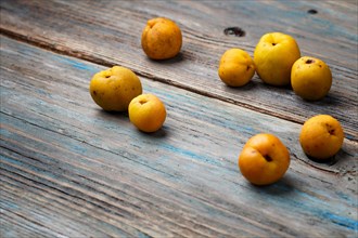 Fresh yellow fruits on a blue rustic wooden background. Concept of contrast
