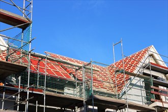 New construction of a multi-family house. The roof is currently being tiled