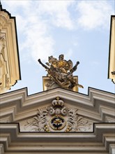 Sculpture, depiction of a saint on the gable of the church, Archangel Michael pushing Lucifer into