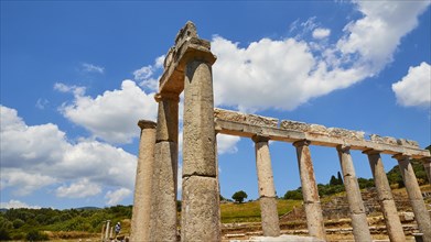 Ancient portico under a blue sky with white clouds, Archaeological site, Ancient Messene, capital