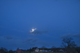 Cloud with full moon in the early evening, Bavaria, Germany, Europe