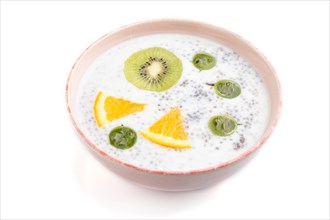 Yogurt with kiwi, gooseberry, chia in ceramic bowl isolated on white background. Side view, close