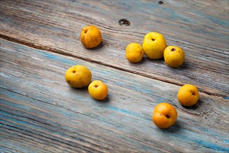 Fresh yellow fruits on a blue rustic wooden background. Concept of contrast