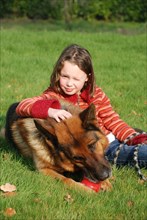 Portrait of a young girl petting her dog