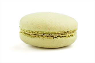 Single green macaron or macaroon cake isolated on white background. side view, close up, macro