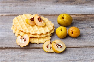 Sweet waffle and quince on a rustic wooden background