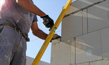 Construction worker (bricklayer) on the building site