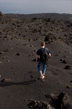 Walking barefooted over volcanic sand of the Teneguia volcano, La Palma, Canary Islands, Spain,