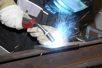 Metalworker during welding work in his workshop