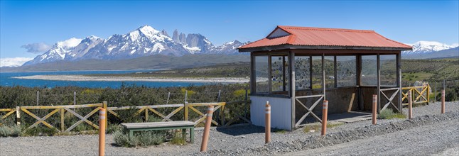 Mountain range with lake, in the foreground hut with wildlife protection fence, Torres del Paine