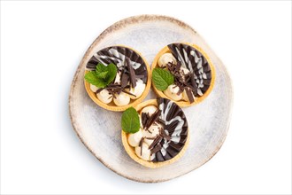 Sweet tartlets with chocolate and cheese cream isolated on white background. top view, flat lay,