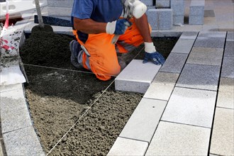 Worker lays paving stones
