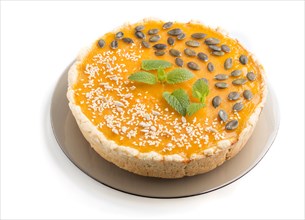 Traditional american sweet pumpkin pie decorated with mint, sesame and pumpkin seeds isolated