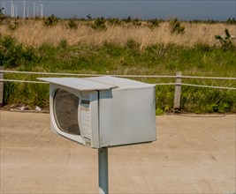 Small microwave oven on metal pole used as mailbox in South Korea