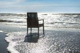 Upholstered chair washed up on the North Sea shore, flotsam, Oksbol, Region Syddanmark, Denmark,