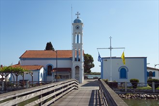 Church during the day with blue sky and access via a wooden bridge, Monastery of St Nicholas,