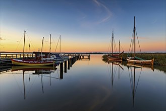 Old sailing boats in the harbour of Wieck on the Darss in the morning light