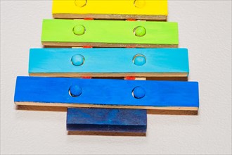 Closeup of small wooden toy xylophone hand painted in bright primary colors