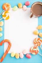 Composition with candies frame on blue pastel background. copy space, top view, flat lay, template