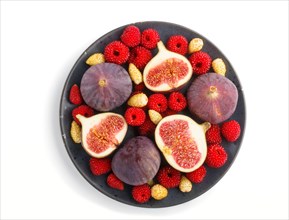 Fresh figs, strawberries and raspberries on blue ceramic plate isolated on white background. top