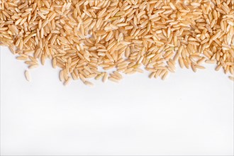 Texture of brown rice isolated on white background. Top view. Copy space