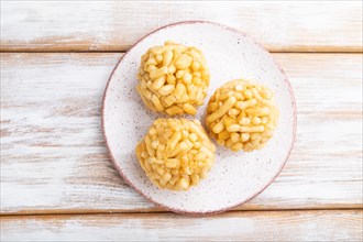 Traditional Tatar candy chak-chak made of dough and honey on a white wooden background. top view,