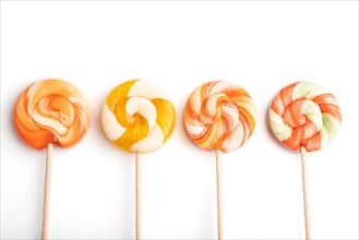 Four lollipop candies isolated on white background. close up, top view, flat lay