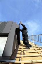 Roofer working on a new dormer window