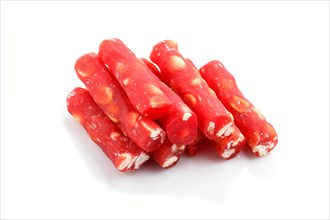 Red traditional turkish delight (rahat lokum) with peanuts isolated on white background. side view,