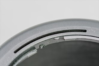 Closeup of top lip of lens hood with focus of locking ring on inside edge