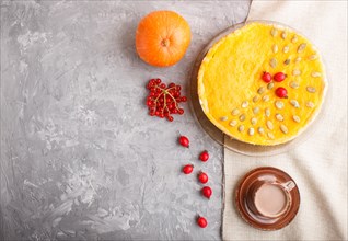 Traditional american sweet pumpkin pie decorated with hawthorn red berries and pumpkin seeds with