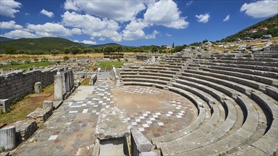 The ancient theatre with its ruins and steps under a cloudy sky, sanctuary of Asclepius,