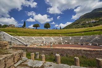 View of an amphitheatre with surrounding trees and mountains in the background, Ancient Theatre,