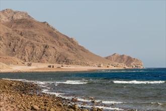 The coastline of the Red Sea and the mountains in the background. Egypt, the Sinai Peninsula, Dahab