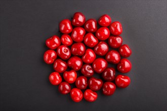 Cherries on black background, top view, flat lay, close up