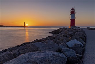 The two lighthouses of Warnemuende near Rostock on the Baltic Sea at sunset as a long exposure