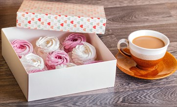 Pink and white homemade marshmallows (zephyr) with cup of coffee on a gray wooden background
