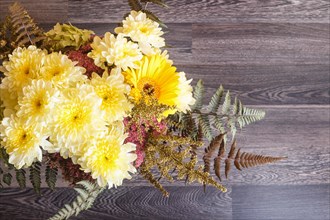 Bouquet of gerbera and chrysanthemum on a wooden background. floristic composition. copy space
