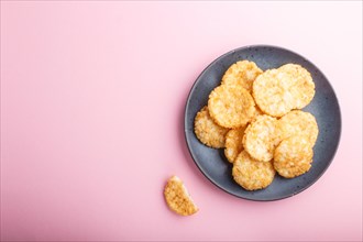 Traditional japanese rice chips cookies with honey and soy sauce on a pastel pink background. Top