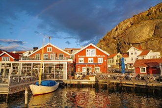 Small harbour with restaurants and rocks in the last light of the day, autumn atmosphere,