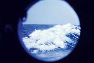 Ocean wave seen through a porthole