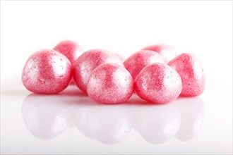 Heap of pink hard sugar candies isolated on white background