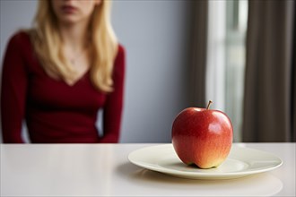 Plate with single apple fruit on plate with blurry woman in background. Dieting concpet. KI