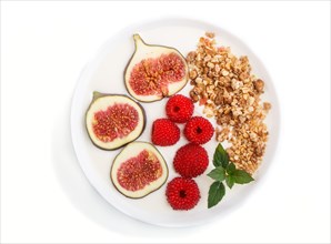 Yoghurt with raspberry, granola and figs in white plate isolated on white background. top view,